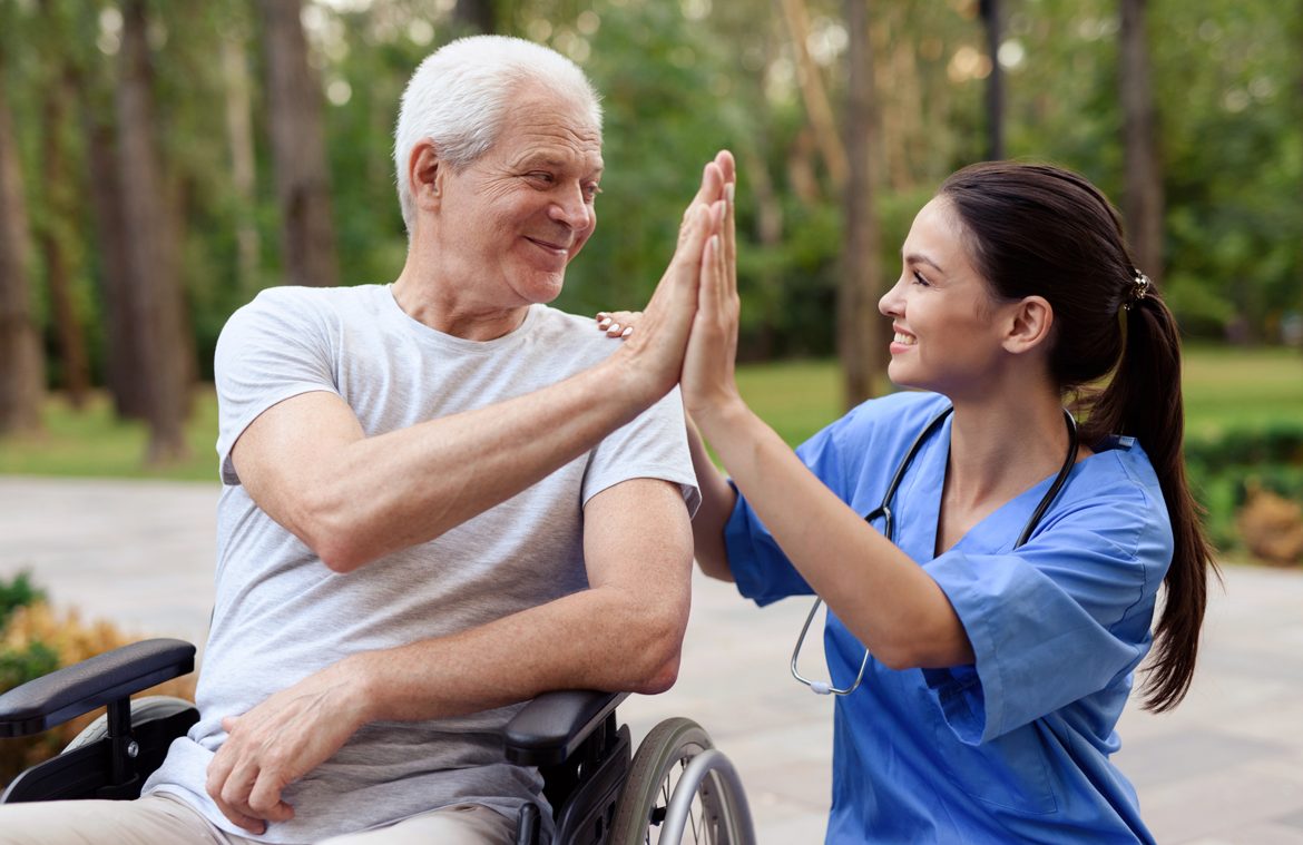 nurse old man wheelchair high five